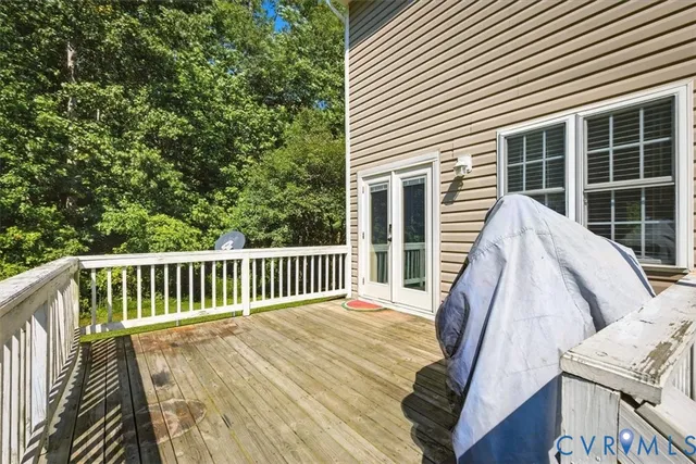a view of balcony with wooden floor and fence