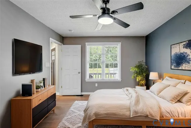 a bedroom with a bed and a flat screen tv