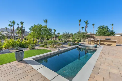 a view of a swimming pool with outdoor seating and plants