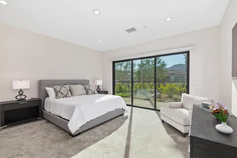 a bedroom with a bed and a large window