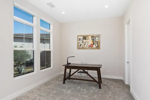 a bench sitting in a room next to a window