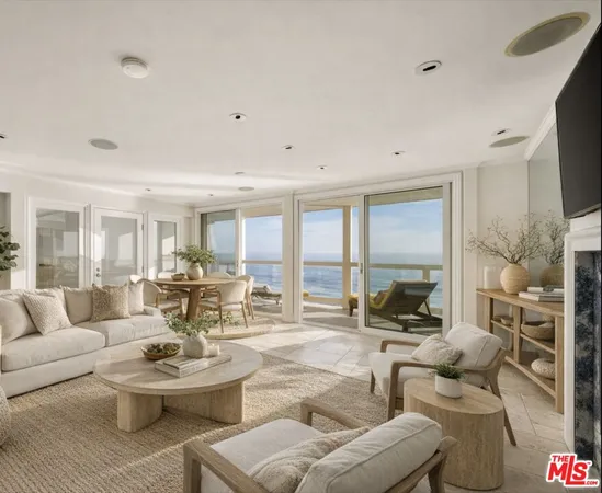 a living room with furniture flat screen tv and a large window