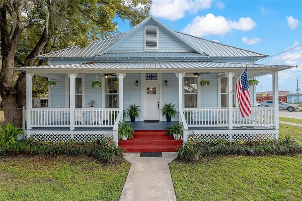 a front view of a house with a garden and deck