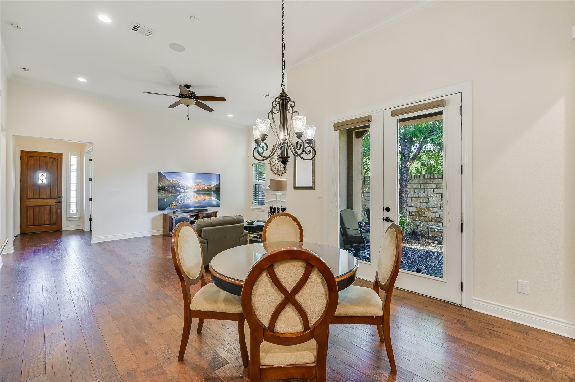 104-2 Rivalto Circle, Unit 1 Lakeway, TX 78734 - Photo 11 of 27 Dining area open to the kitchen and living room featuring wood flooring and high ceilings