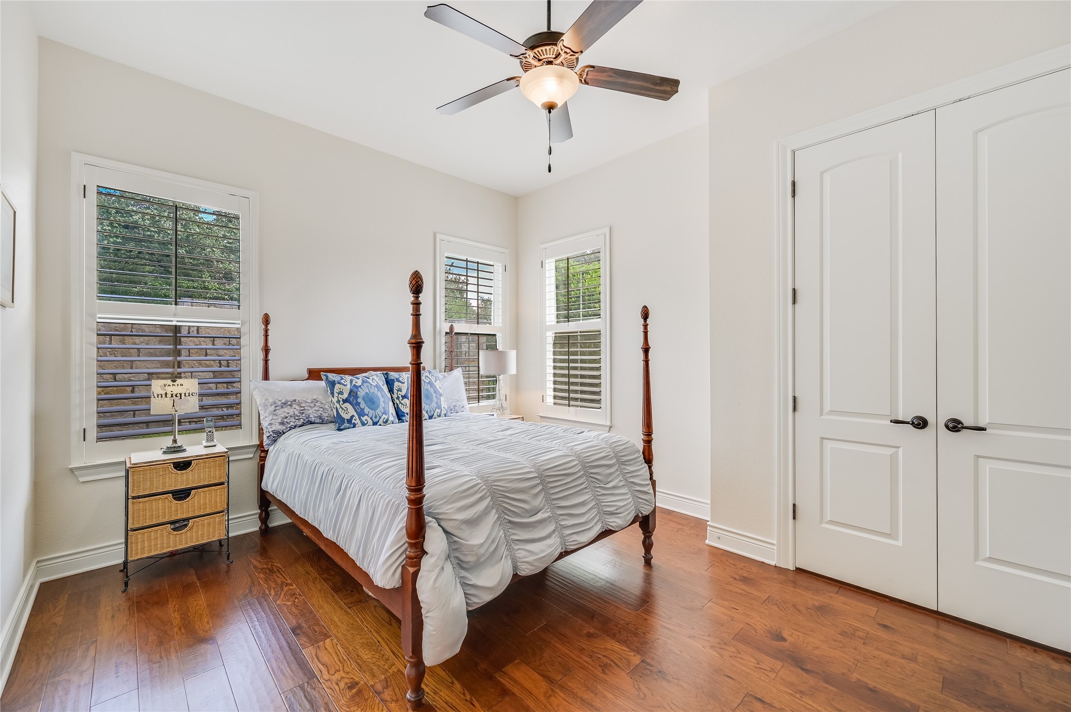 104-2 Rivalto Circle, Unit 1 Lakeway, TX 78734 - Photo 15 of 27 Bedroom featuring wood flooring, a ceiling fan and recessed lights