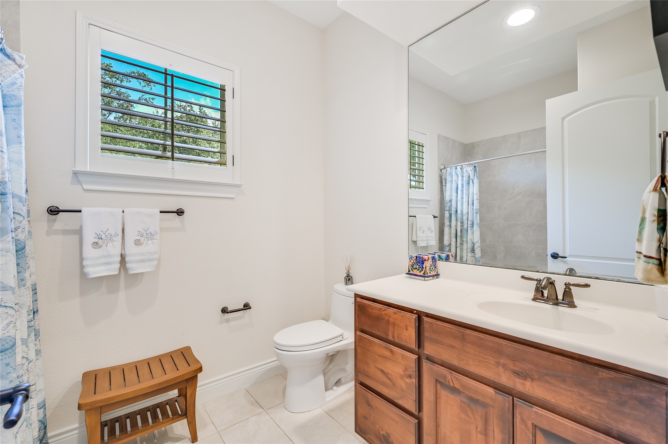 104-2 Rivalto Circle, Unit 1 Lakeway, TX 78734 - Photo 16 of 27 Full bathroom with a vanity, a tub/shower and tile floors