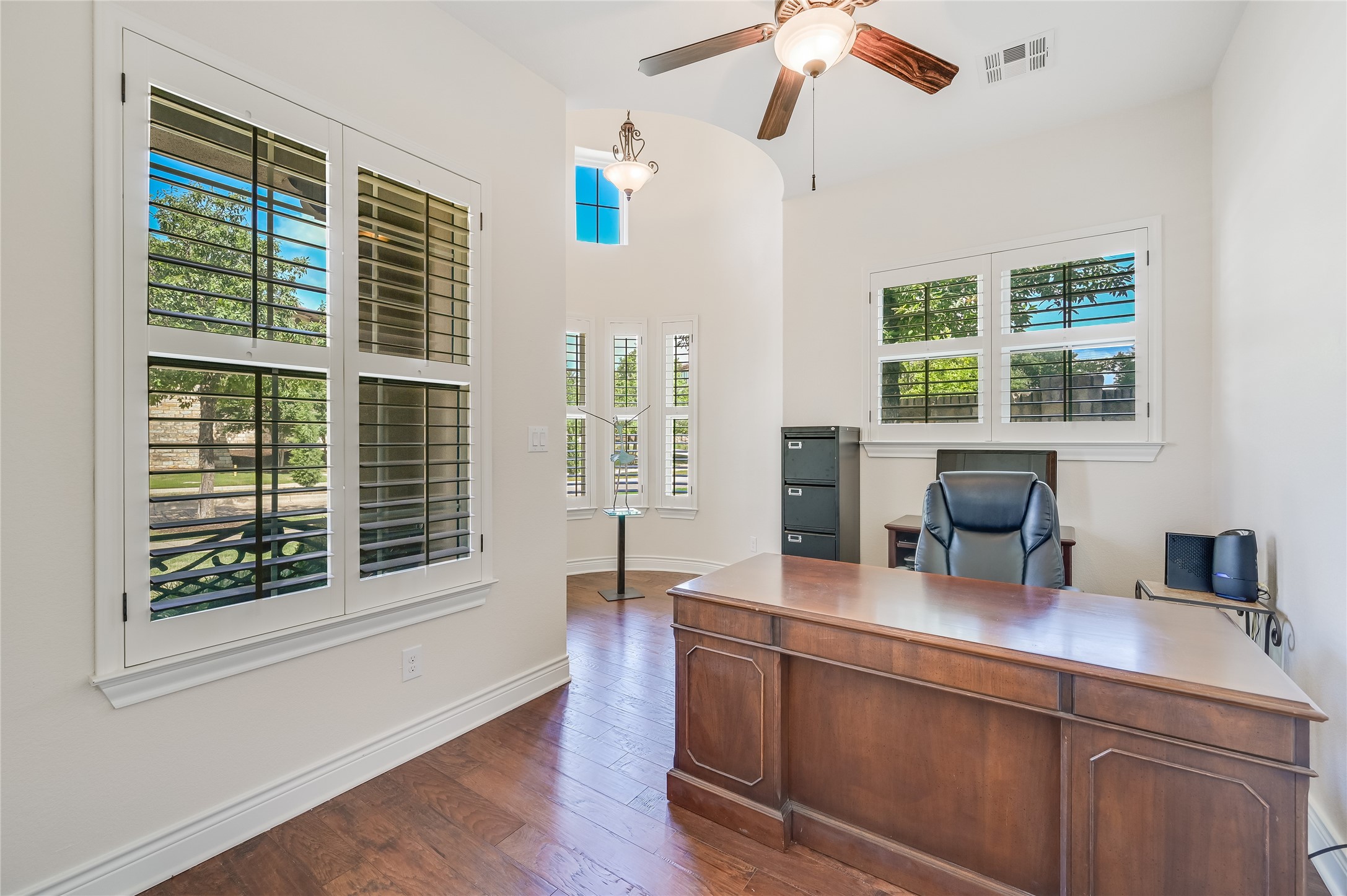 104-2 Rivalto Circle, Unit 1 Lakeway, TX 78734 - Photo 17 of 27 Office room featuring wood floors, a ceiling fan and a rotunda