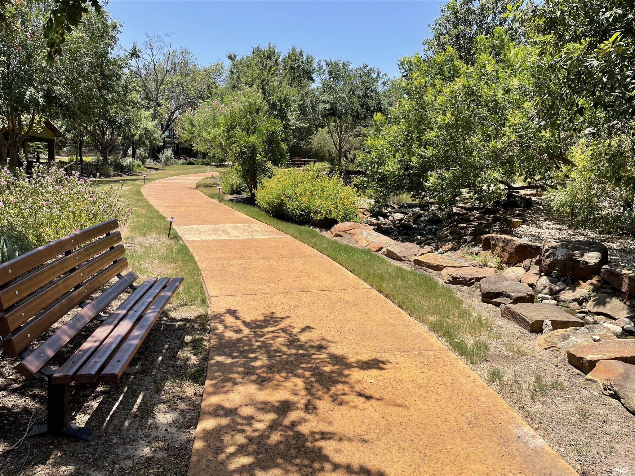 104-2 Rivalto Circle, Unit 1 Lakeway, TX 78734 - Photo 26 of 27 Tuscan Village Community walking path with park bench