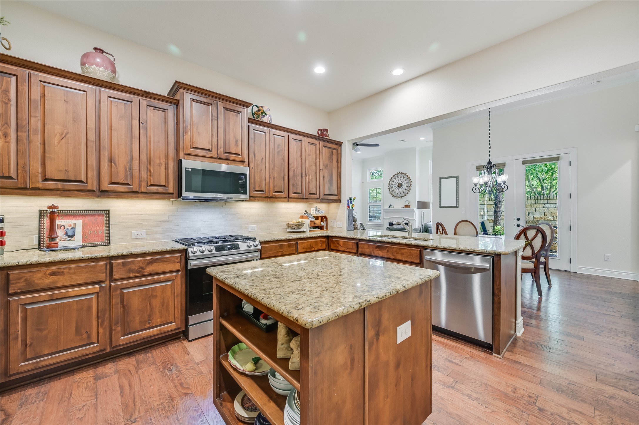 104-2 Rivalto Circle, Unit 1 Lakeway, TX 78734 - Photo 7 of 27 Kitchen with tons of cabinets, stainless steel appliances, granite countertops, recessed lighting and a large granite island