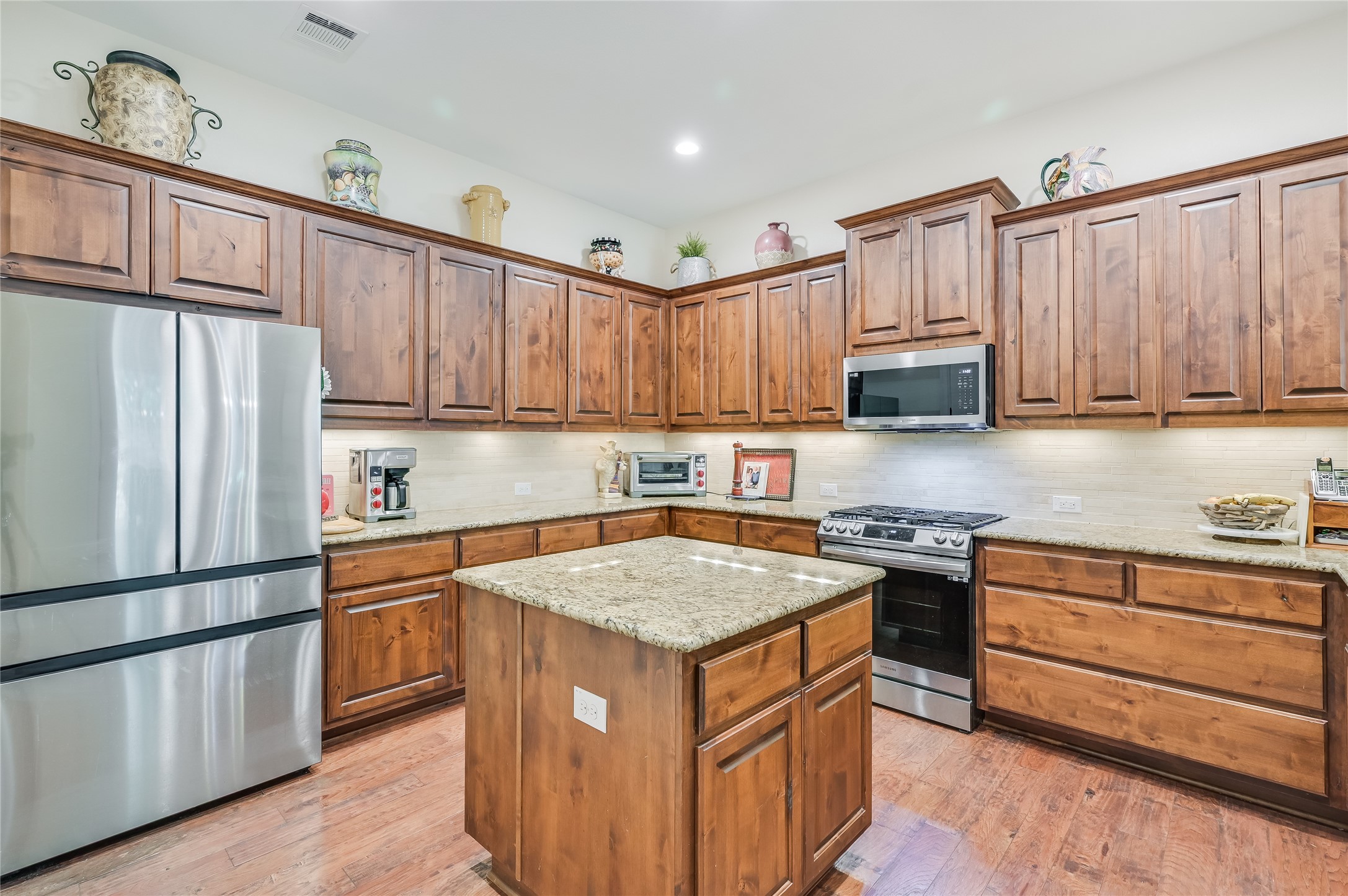 104-2 Rivalto Circle, Unit 1 Lakeway, TX 78734 - Photo 8 of 27 Kitchen with tons of cabinets, stainless steel appliances, granite countertops, recessed lighting and a large granite island