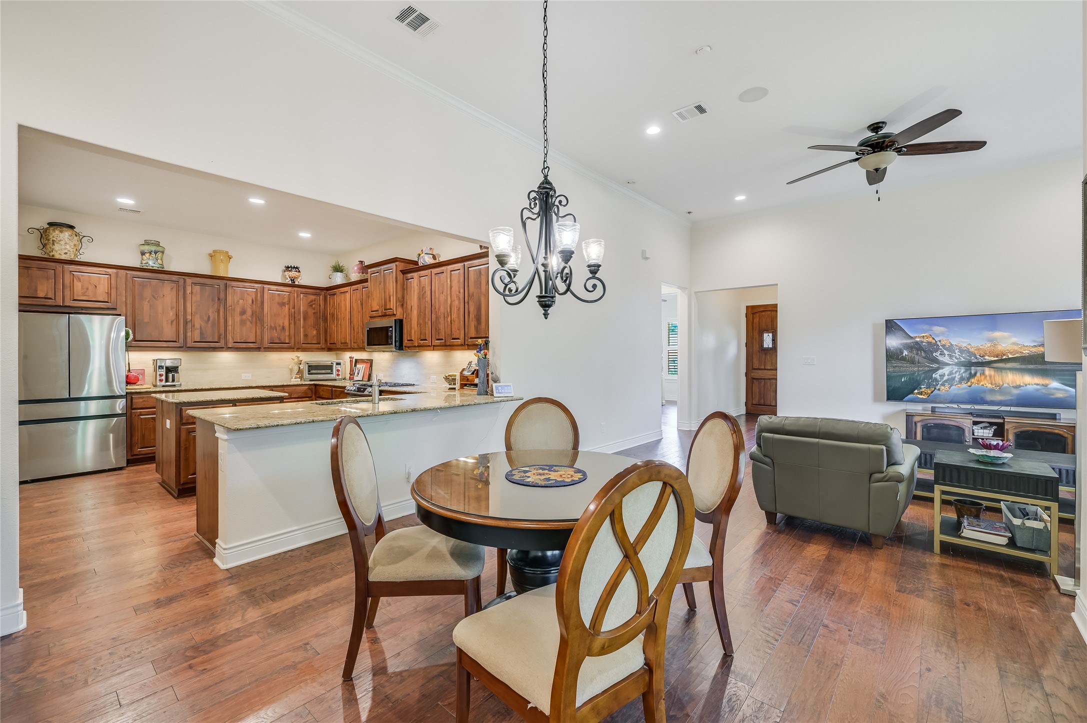104-2 Rivalto Circle, Unit 1 Lakeway, TX 78734 - Photo 10 of 27 Dining area open to the kitchen and living room featuring wood flooring and high ceilings