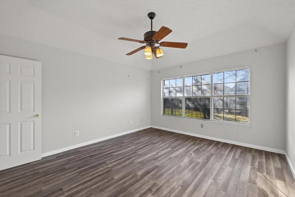 920 Danforth Place Arlington, TX 76017 - Photo 17 of 28 a view of an empty room with wooden floor and a window