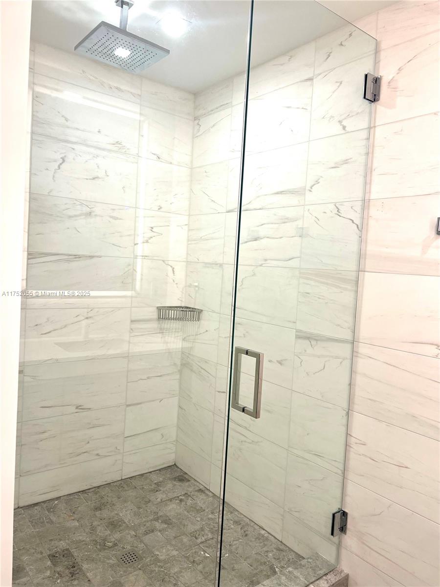 200 Sunrise Drive, Unit 200C Key Biscayne, FL 33149 - Photo 11 of 16 a bathroom with a shower