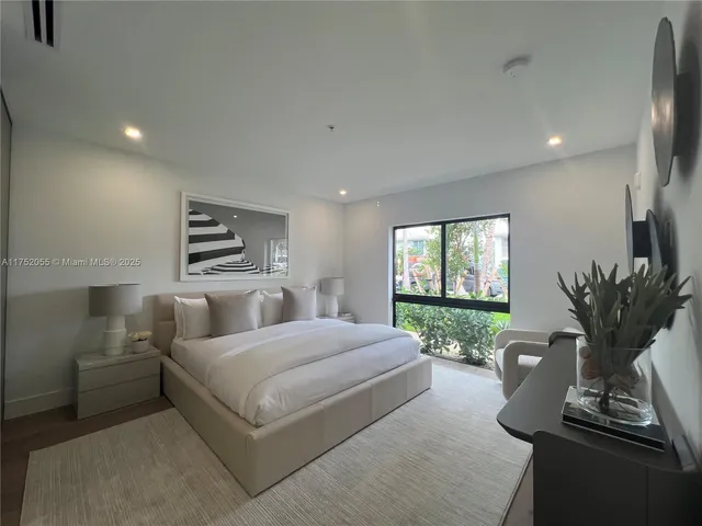 a bed room with a bed and a potted plant