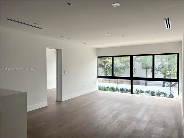 a view of an empty room with a large window