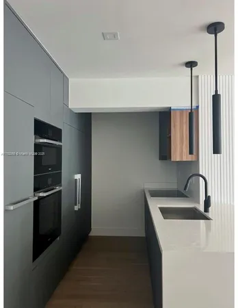 a kitchen with stainless steel appliances a refrigerator and sink