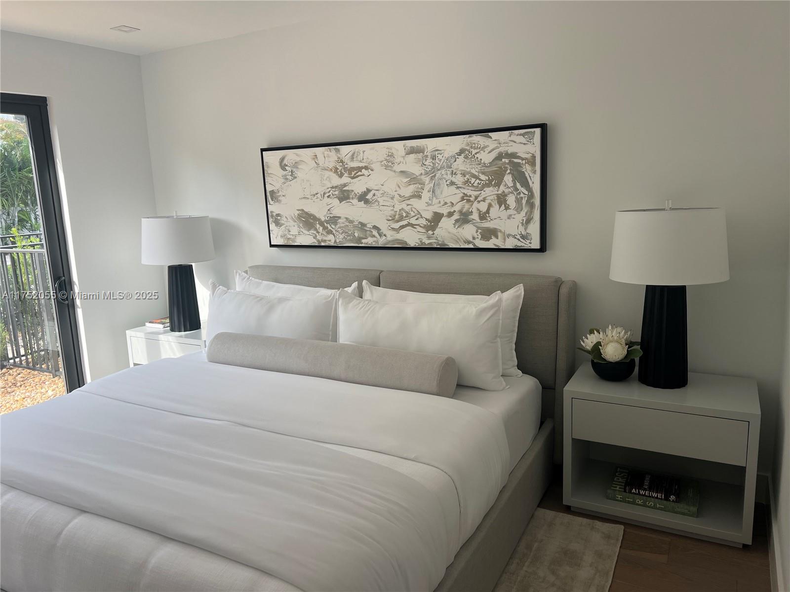 200 Sunrise Drive, Unit 200C Key Biscayne, FL 33149 - Photo 10 of 16 a bedroom with a bed and a painting on the wall