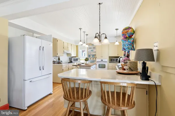 a view of kitchen island with stainless steel appliances