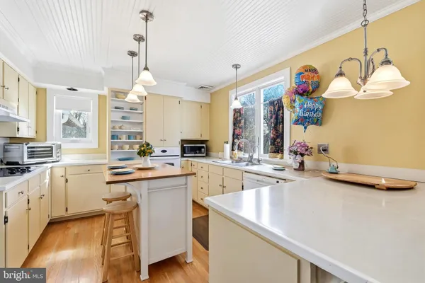 a kitchen with cabinets a sink and appliances