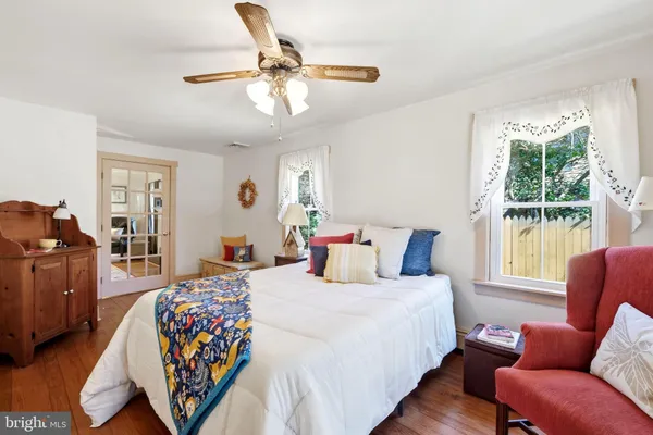 a bedroom with a bed couch and window