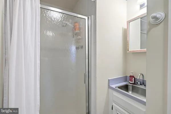 a bathroom with a sink and glass door