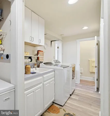 a kitchen with a sink cabinets and wooden floor
