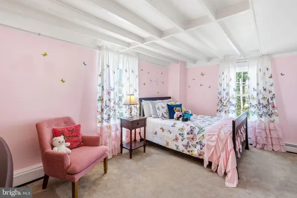 a bedroom with a bed and a couch