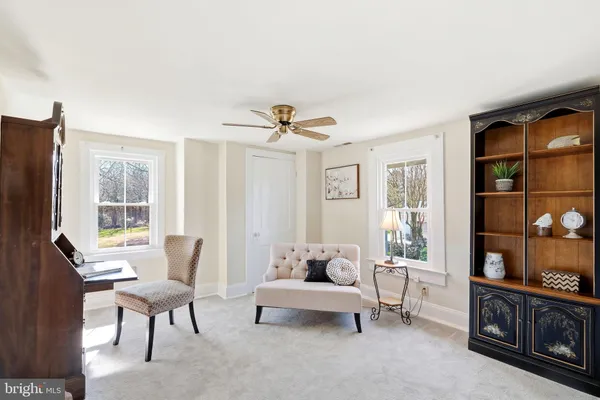 a living room with furniture a lamp and a window
