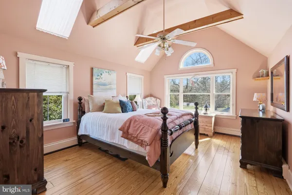 a spacious bedroom with a bed and a large window