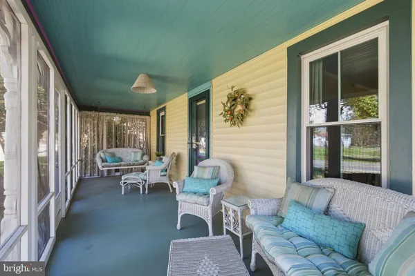 a balcony with furniture and front door