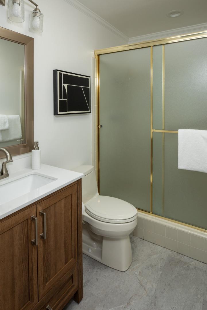 71 Bay Tree Lane Los Altos, CA 94022 - Photo 19 of 32 a bathroom with a sink a toilet a mirror and shower