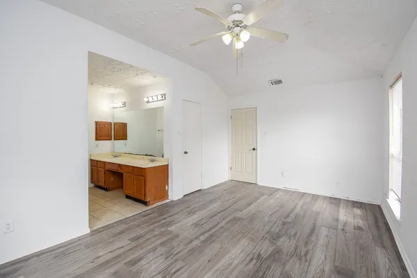 a view of a kitchen with granite countertop cabinets and wooden floor