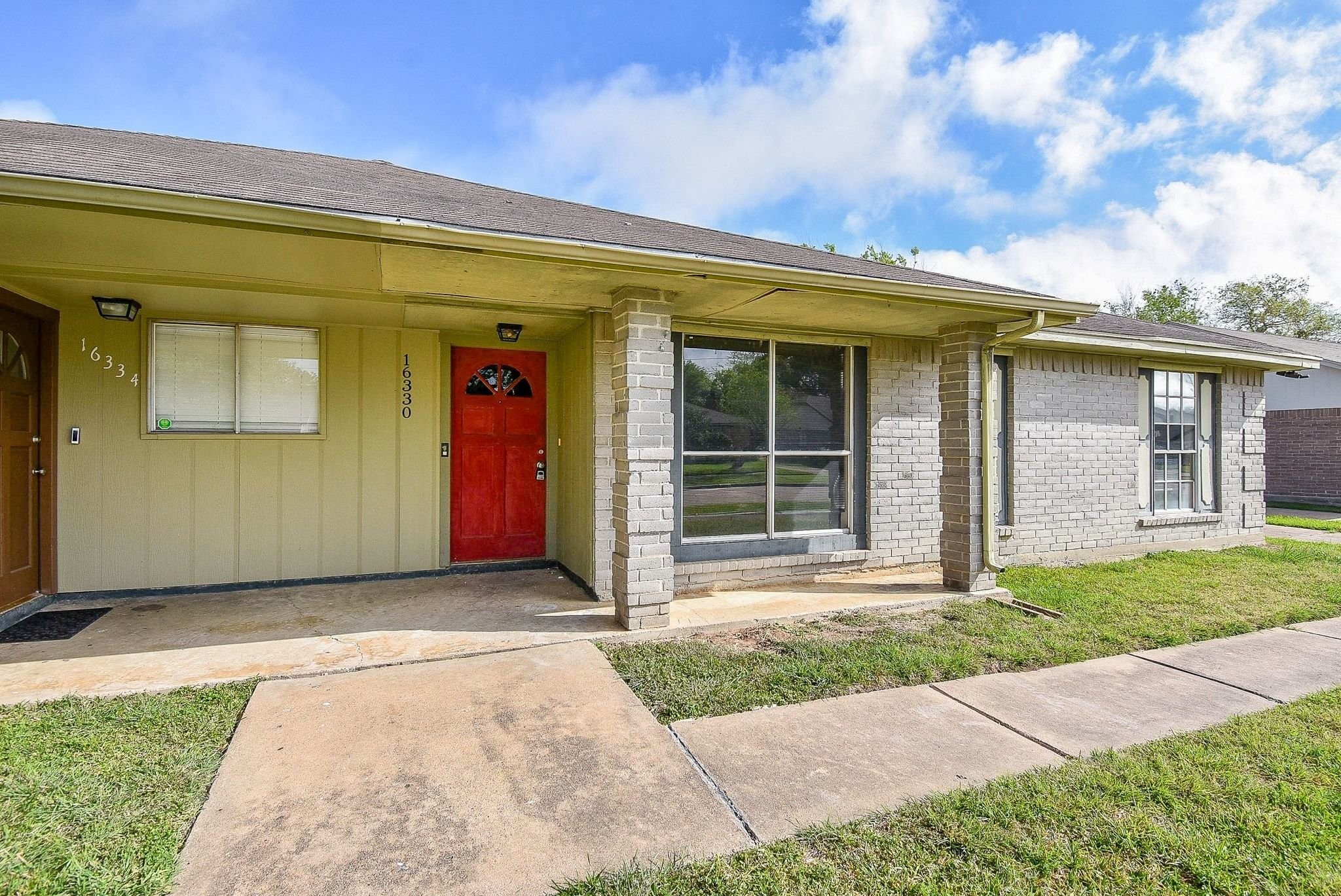 16330 Meadowbrook Farm Road Houston, TX 77082 - Photo 2 of 20 a front view of a house with a yard