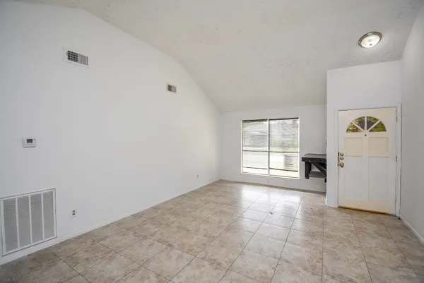 an empty room with windows and closet