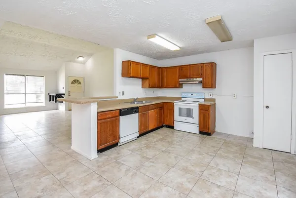 a kitchen with stainless steel appliances granite countertop a stove sink and cabinets