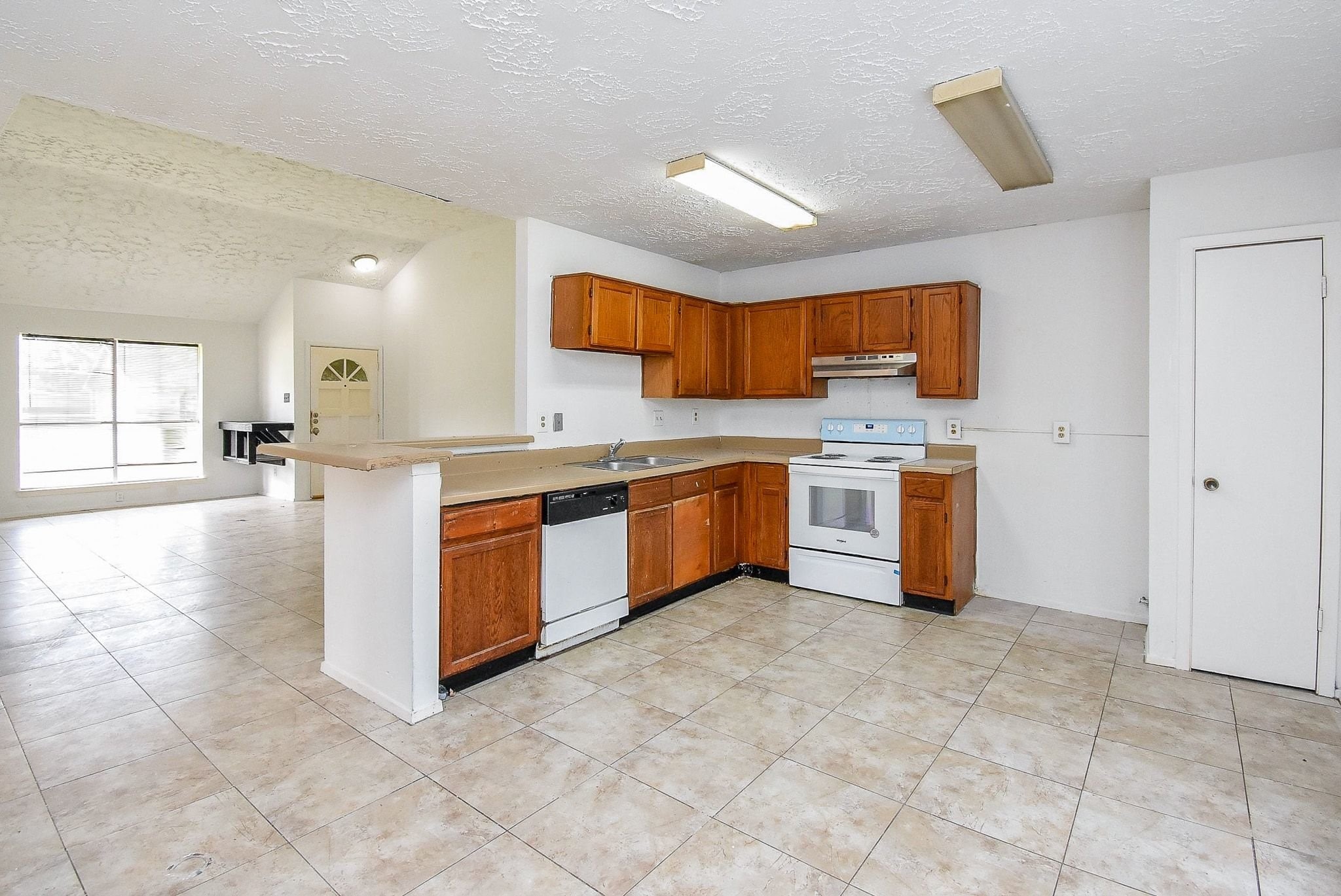 16330 Meadowbrook Farm Road Houston, TX 77082 - Photo 8 of 20 a kitchen with stainless steel appliances granite countertop a stove sink and cabinets