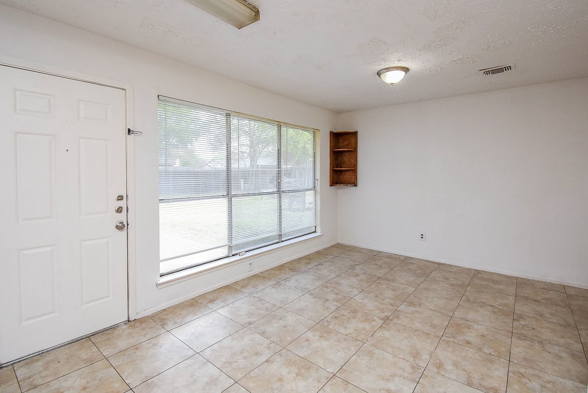 16330 Meadowbrook Farm Road Houston, TX 77082 - Photo 9 of 20 a view of an empty room with a window