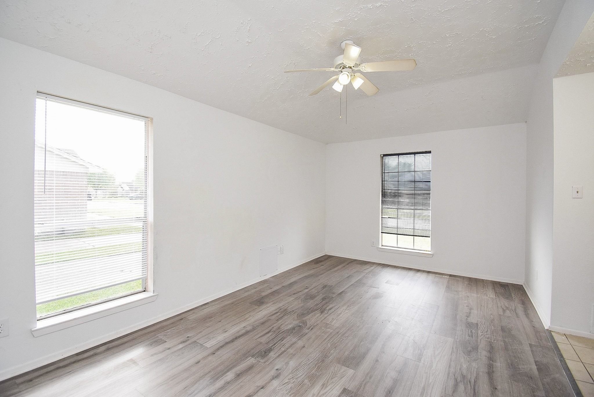 16330 Meadowbrook Farm Road Houston, TX 77082 - Photo 10 of 20 a view of an empty room with wooden floor and a window
