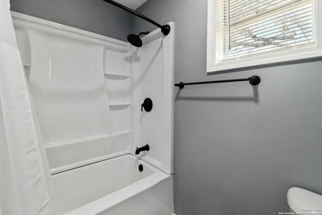 a bathroom with a bathtub and a shower