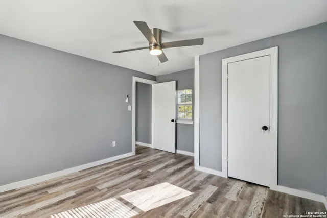 a view of a livingroom with a ceiling fan and wooden floor