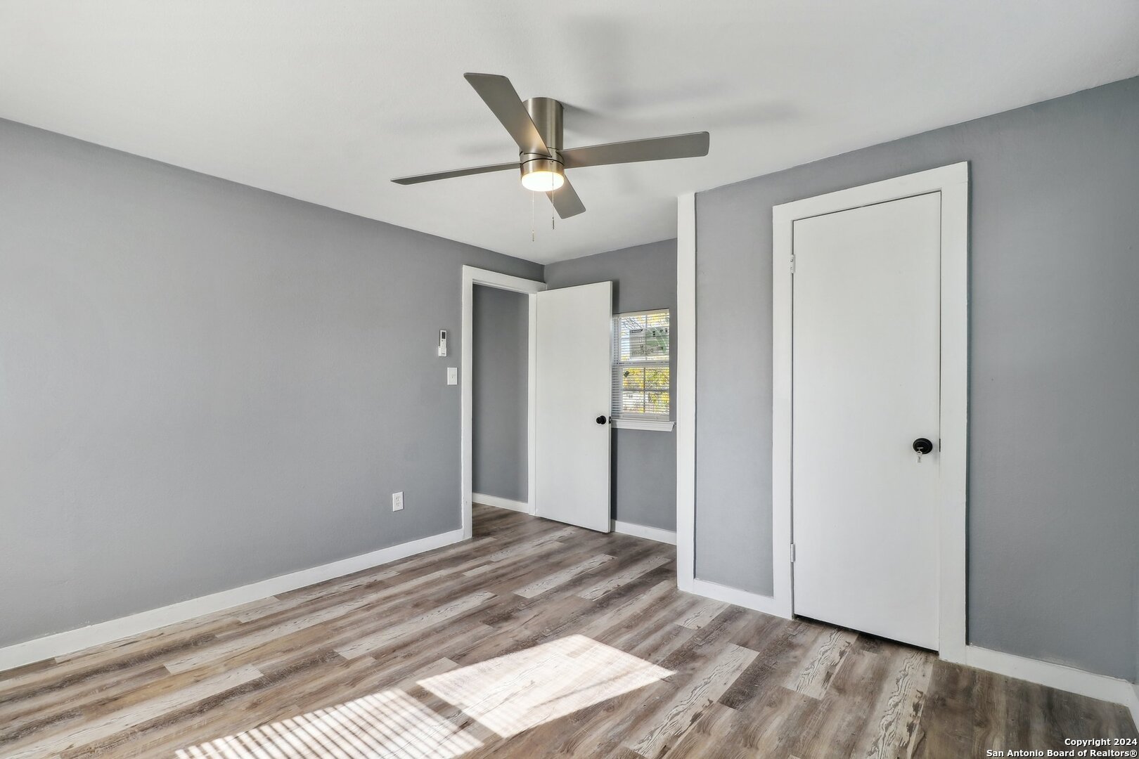 132 Renfro Drive Devine, TX 78016 - Photo 20 of 36 a view of a livingroom with a ceiling fan and wooden floor