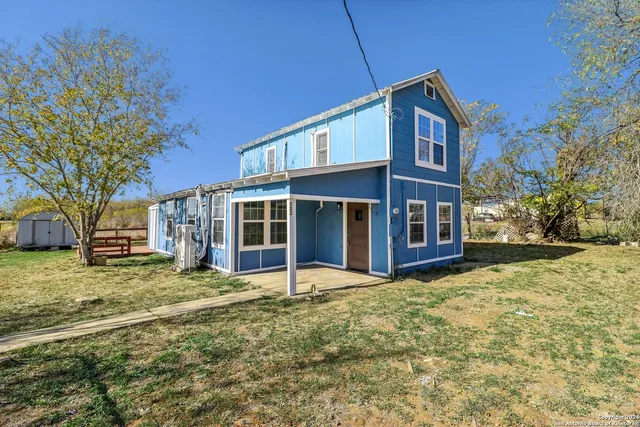 a view of a house with a yard