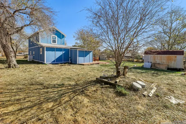 a view of backyard with large tree