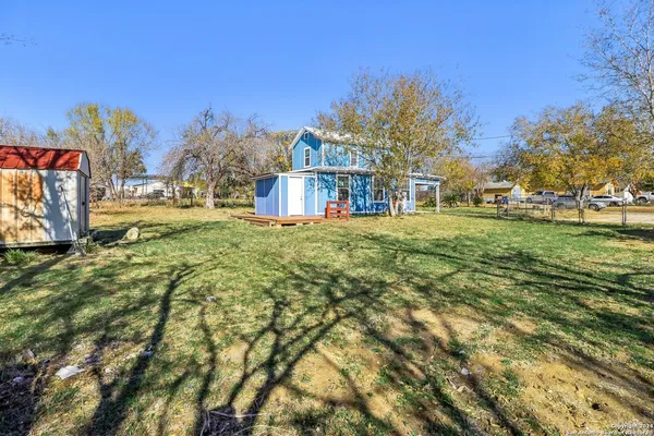 a front view of a house with a yard table and chairs