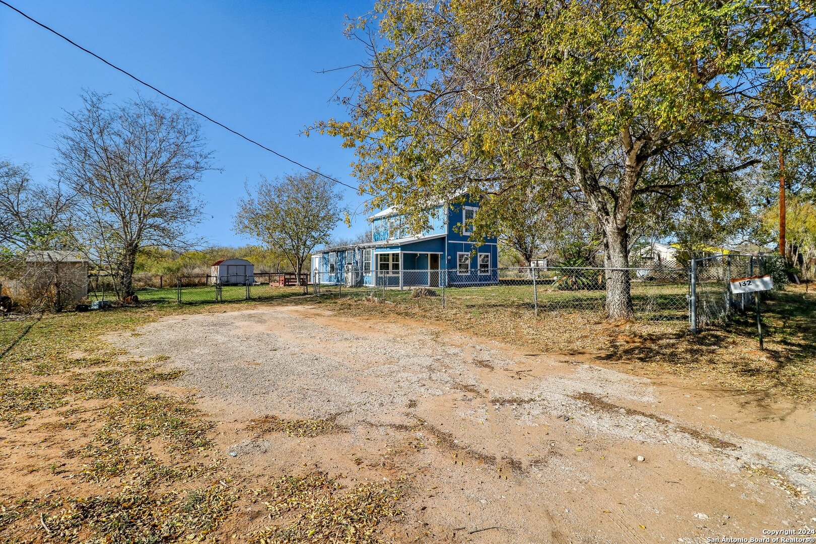 132 Renfro Drive Devine, TX 78016 - Photo 33 of 36 a house with trees in front of it