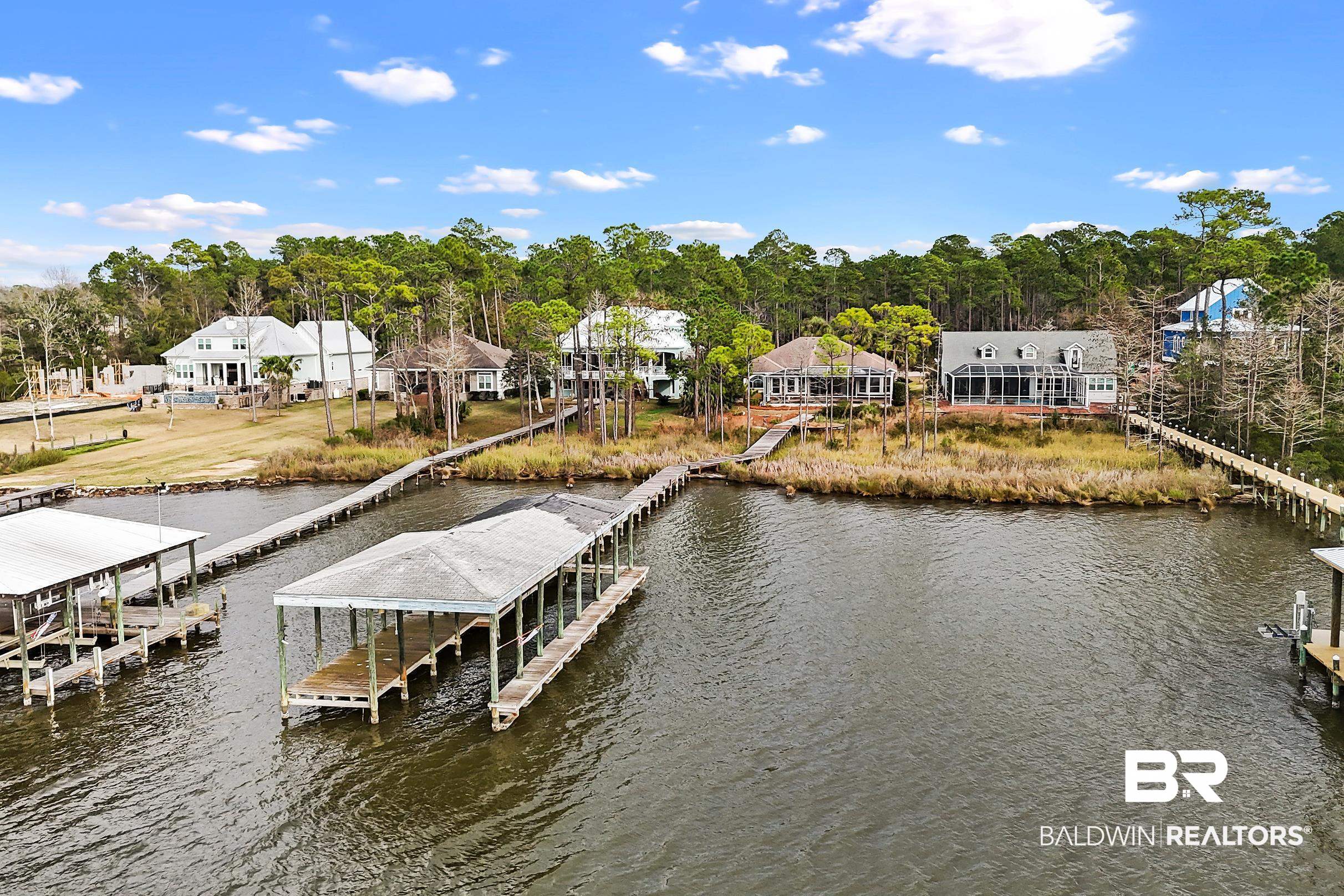 8591 Bay Harbor Road Elberta, AL 36530 - Photo 46 of 56 Dock area with a water view, boat lift, a residential view, and view of wooded area