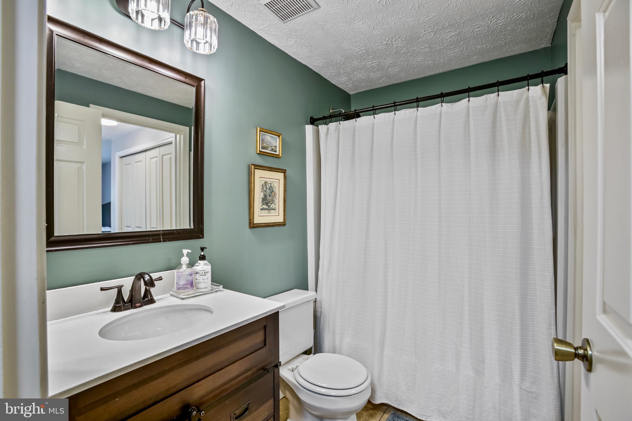 1675 Poplar Grove Drive Reston, VA 20194 - Photo 15 of 32 a bathroom with a sink vanity mirror and toilet