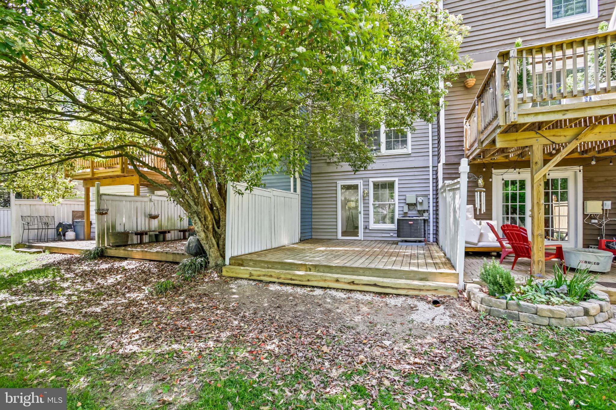 1675 Poplar Grove Drive Reston, VA 20194 - Photo 22 of 32 a view of a house with a large tree and a yard