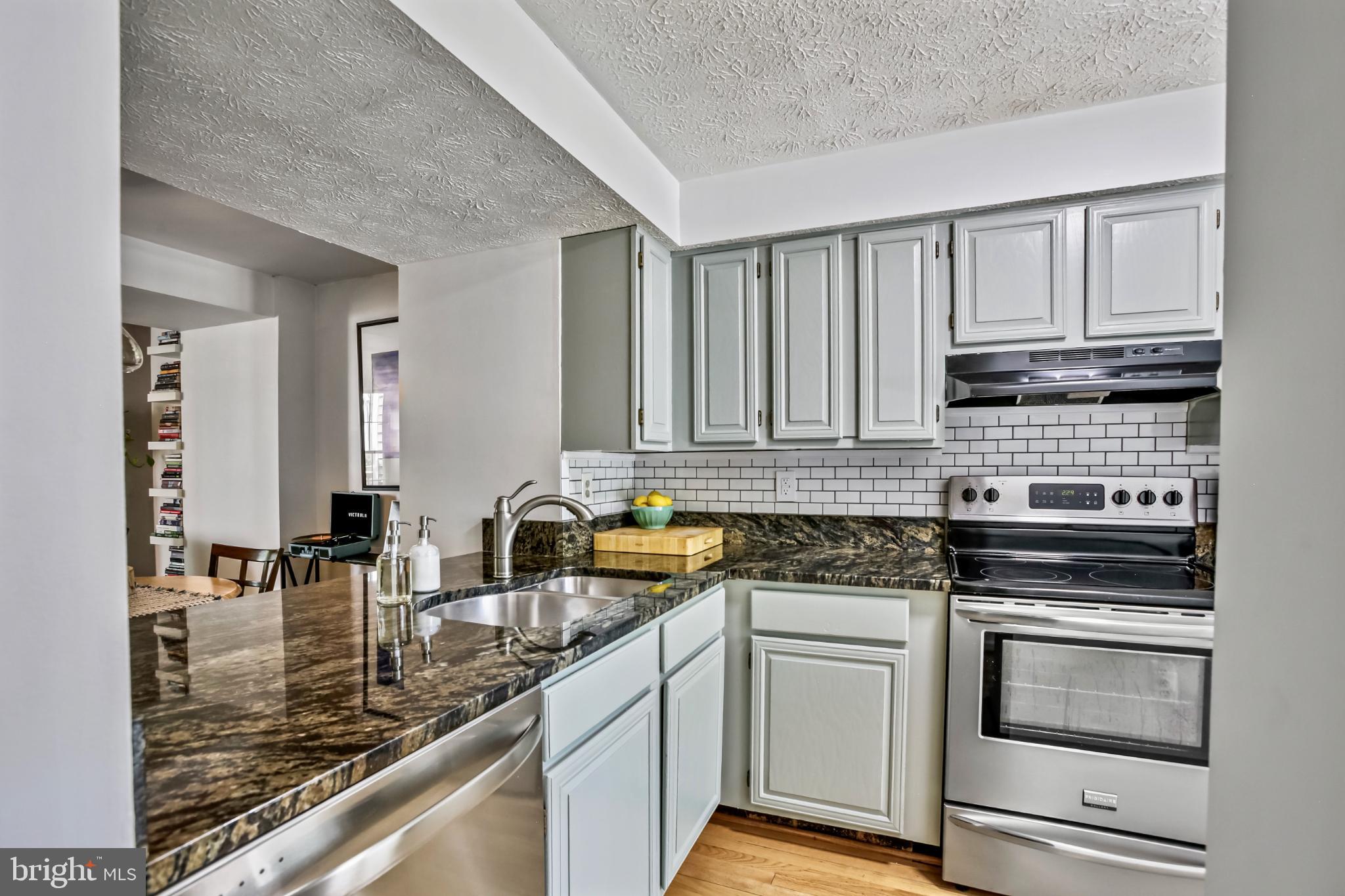 1675 Poplar Grove Drive Reston, VA 20194 - Photo 3 of 32 a kitchen with stainless steel appliances granite countertop a stove sink and cabinets