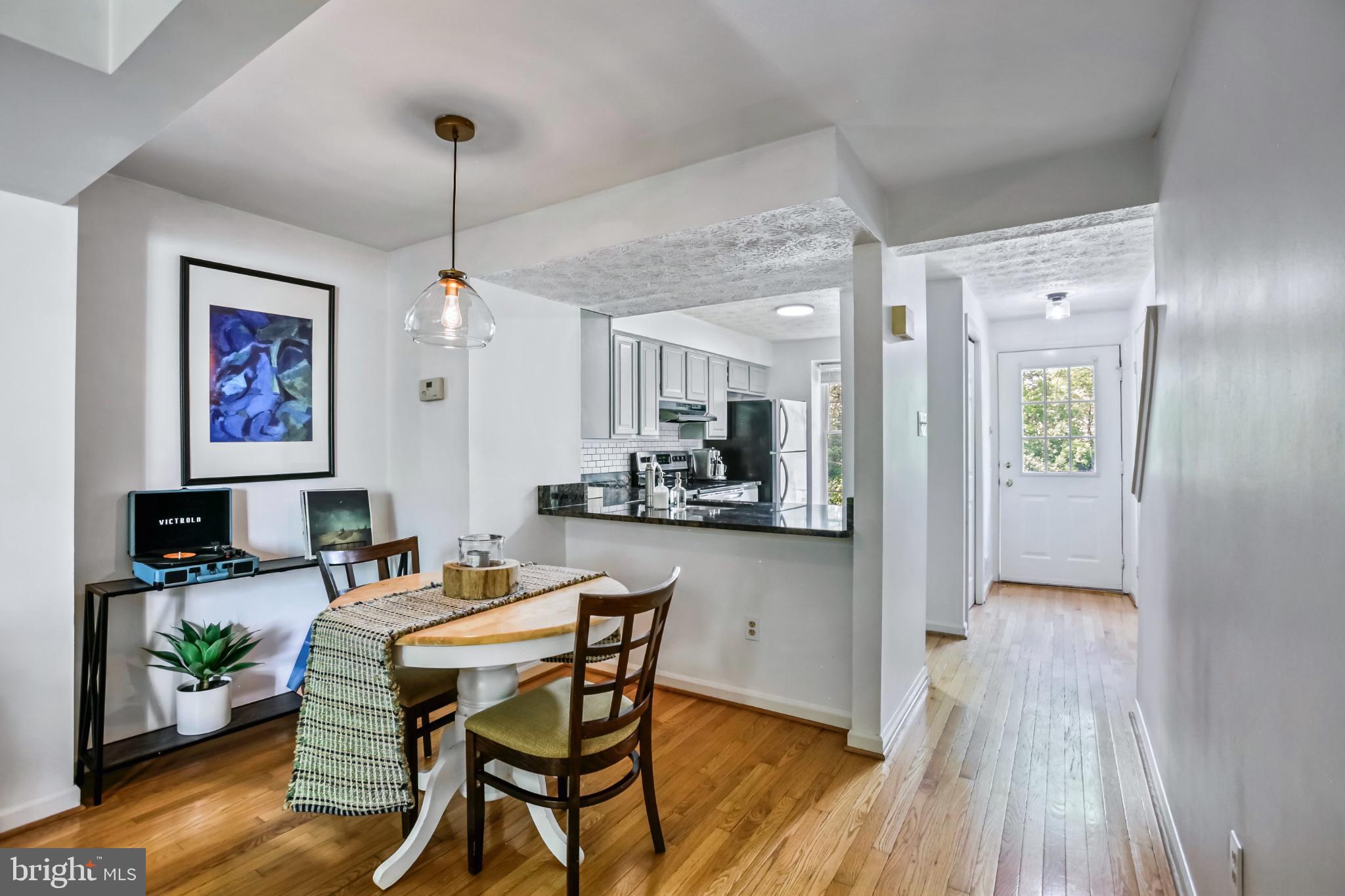 1675 Poplar Grove Drive Reston, VA 20194 - Photo 5 of 32 a view of a dining room with furniture wooden floor and a chandelier